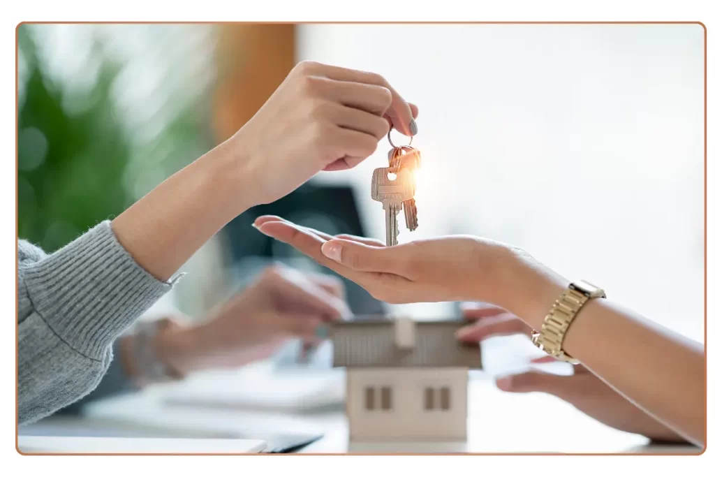 a person handing a key to a house