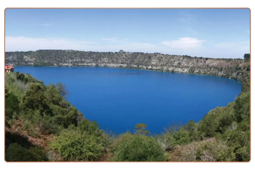 a blue lake surrounded by trees with Blue Lake in the background