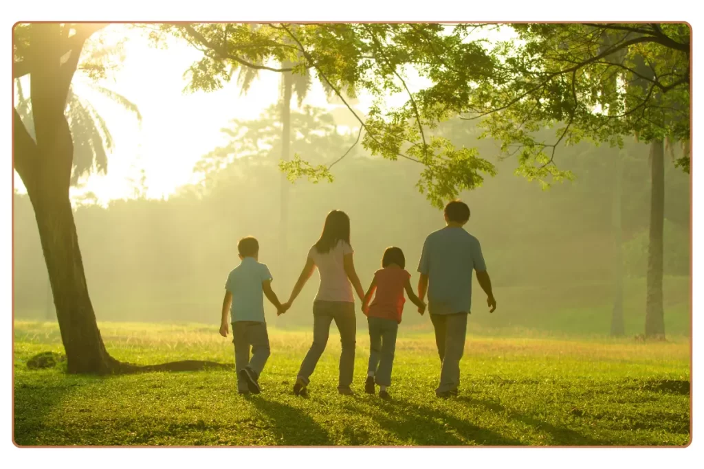 A happy family walking in a park